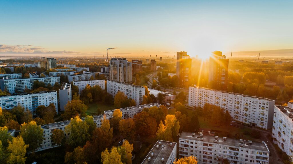 pexels-photo-681368-681368 Aerial view of a cityscape at sunrise with autumn foliage and modern buildings.